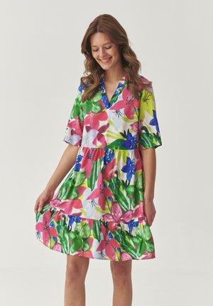 Floral dress with vibrant pink, green, and blue patterns. Short sleeves, v-neck, and tiered ruffled hem. Made from lightweight fabric.
