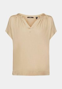 Top beige à manches courtes en tissu lisse. Il présente un décolleté en V avec des détails froncés aux épaules et un ourlet droit.