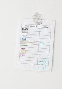 Color variation chart taped to a white wall, listing colors with only "beige/brown" marked as 3 in the amount column in blue ink.