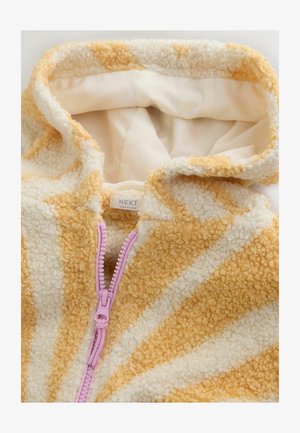 Pluszowa, kremowo-żółta kurtka z kapturem i przednim zamkiem błyskawicznym w kolorze lawendowym. Tkanina o teksturowanej powierzchni z miękkim wykończeniem i kontrastującym paskowanym wzorem.