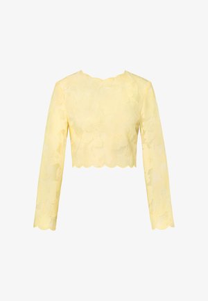 Gul langermet croptop med blomstermønster i blonder og bølgete kanter på halsringning, kant og mansjetter.