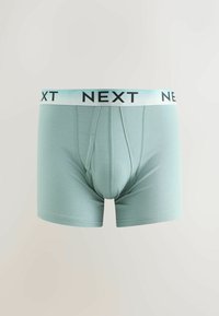 Caleçons pour hommes bleu clair avec une ceinture blanche portant le mot « NEXT » en lettres noires.