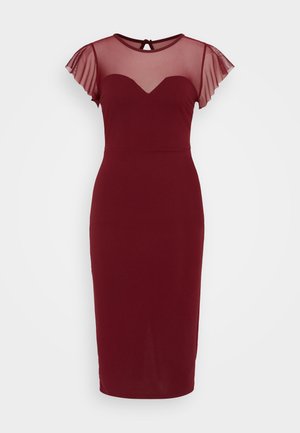 Μπορντό φόρεμα με εφαρμοστή σιλουέτα, διάφανες μανίκες από δίχτυ και λαιμόκοψη σε σχήμα καρδιάς. Μαλακό ύφασμα με υφασματικές λεπτομέρειες.