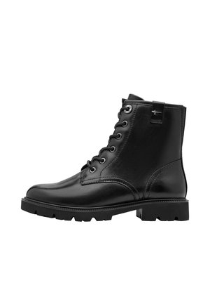 Black leather ankle boot with lace-up front, thick lug sole, and small pull tab on the side showing a metallic logo.