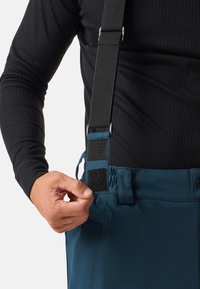 Pantaloni in tessuto blu navy con bretelle nere regolabili. Include una cintura texturizzata con velcro e un pannello elastico per la regolazione della vestibilità.