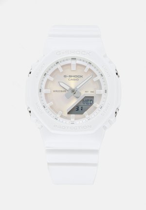 White G-Shock digital watch with a textured bezel, clear face, silver accents, and a digital display showing the day and date. WR20BAR.