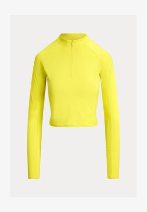 Geel crop top met lange mouwen, voorzien van een hoge kraag en een halve rits. Gladde, rekbare stof met minimale naden en een aangesloten pasvorm.