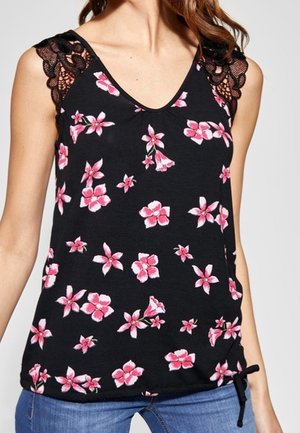 Black sleeveless top with pink floral print, V-neck, lace shoulder details, and a drawstring hem, worn with blue jeans.