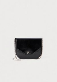 Black leather crossbody bag with silver chain strap and small silver logo on front, set against plain light background.