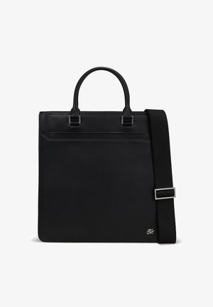 Black leather tote bag with dual handles and a removable shoulder strap. Features a front pocket and silver-tone hardware detail.