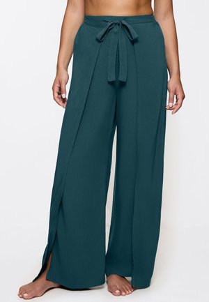 Schöne türkisfarbene Hosen mit weitem Bein aus leichtem Stoff. Mit Taillenband und seitlichen Schlitzen für Bewegungsfreiheit. Glatte Textur und klares Design.