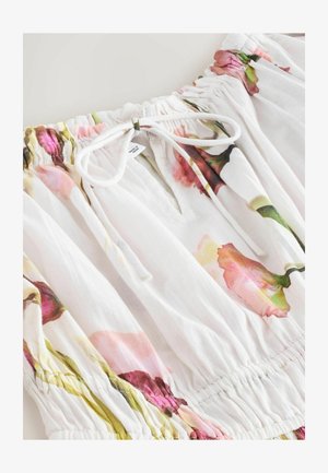 Blusa con motivo floreale rosa e verde su tessuto bianco, dotata di scollo elasticizzato e dettaglio con coulisse. Tessuto leggero.