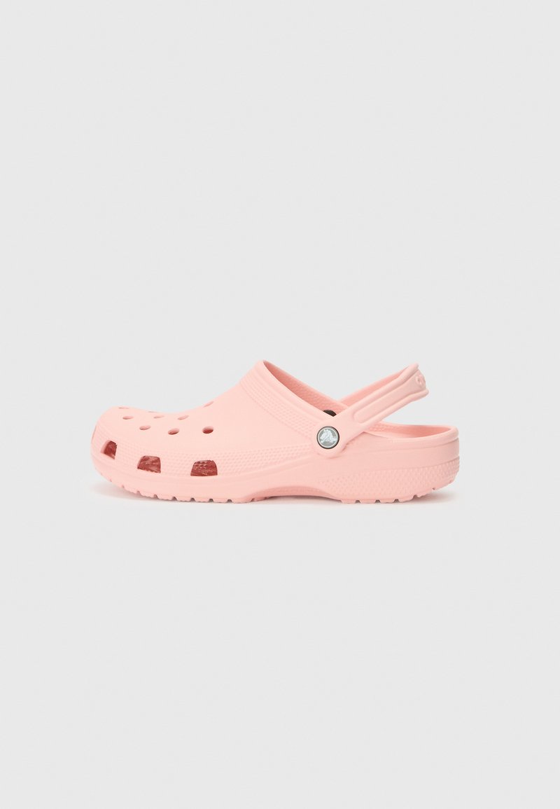 Pink rubber clog with perforated design, adjustable heel strap, and textured sole for traction. Smooth finish with a round toe.