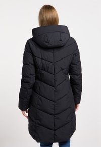 Black padded coat with a chevron pattern, hood, and long sleeves, featuring a straight cut and textured fabric.