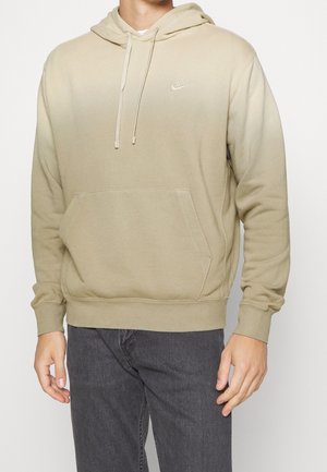 Ombre-beige Kapuzenpullover mit einer Fronttasche, Kordelzugkapuze und eingesticktem Nike-Logo. Das Material ist weich und hat gerippte Bündchen und Saum.