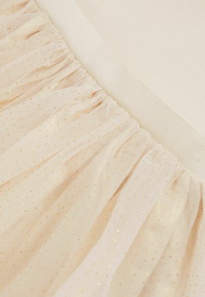 Kreemivärvi tüllkangas on ruššitud disainiga ja kaetud kuldsete fooliumipunktidega. Vöökohale on kasutatud siledat elastset materjali.