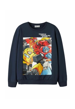 Sweat-shirt bleu foncé avec des personnages colorés de Transformers et le texte "Transformers The Movie" sur la poitrine.