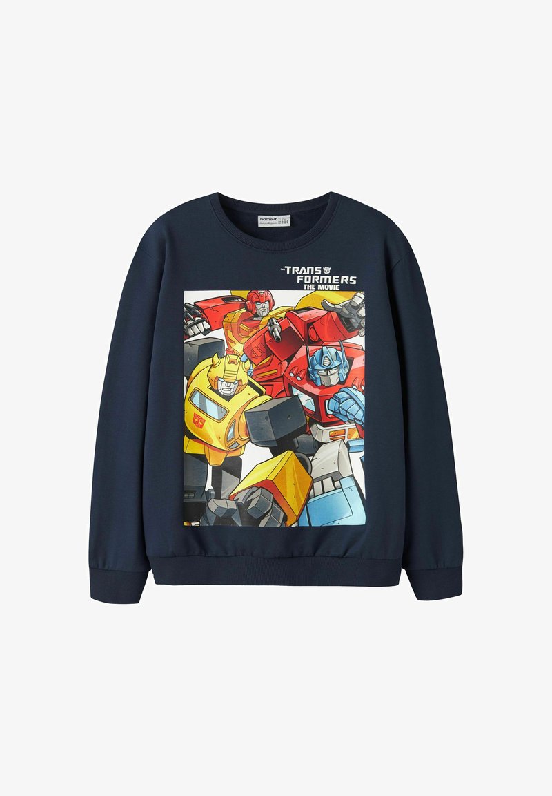 Sweat-shirt bleu foncé avec des personnages colorés de Transformers et le texte "Transformers The Movie" sur la poitrine.