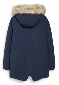 Navy blue parka with a faux fur-trimmed hood, featuring a straight cut, side pockets, and a center back vent for ease of movement.
