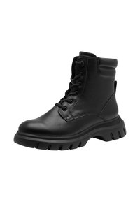 Bottines en cuir noir, à bout rond, à lacets sur le devant et avec un col rembourré. Semelle robuste avec des rainures profondes pour une bonne adhérence.