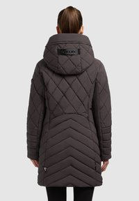 Padded dark gray jacket with a quilted design, featuring a large hood and logo patch. Chevron pattern on the back for added detail.