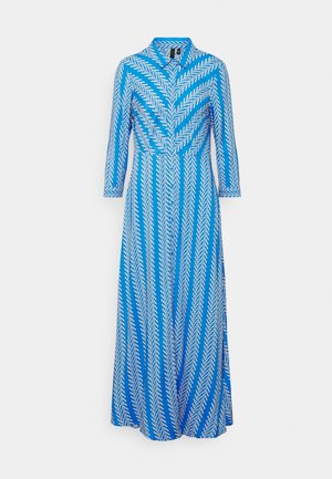 Sininen mekko, jossa on valkoinen herringbone-kuvio, kaulus ja kolme neljännestä hihoista. Väljä materiaali, nilkkapituinen, vyötäröltä huomattavasti istuva ja liehuva hame.