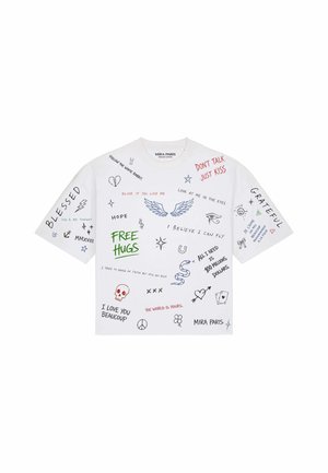 T-shirt bianca a maniche corte con frasi scritte a mano multicolore e scarabocchi che includono ali, serpente, teschio, cuori e simboli di pace.
