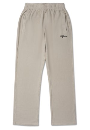 Beige ribbed joggers with an elastic waistband, side pockets, and a small black logo on the left leg. Smooth texture, straight leg design.