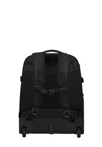 Black wheeled backpack with padded shoulder straps, mesh back, dual zippered compartments, and plastic base for stability.