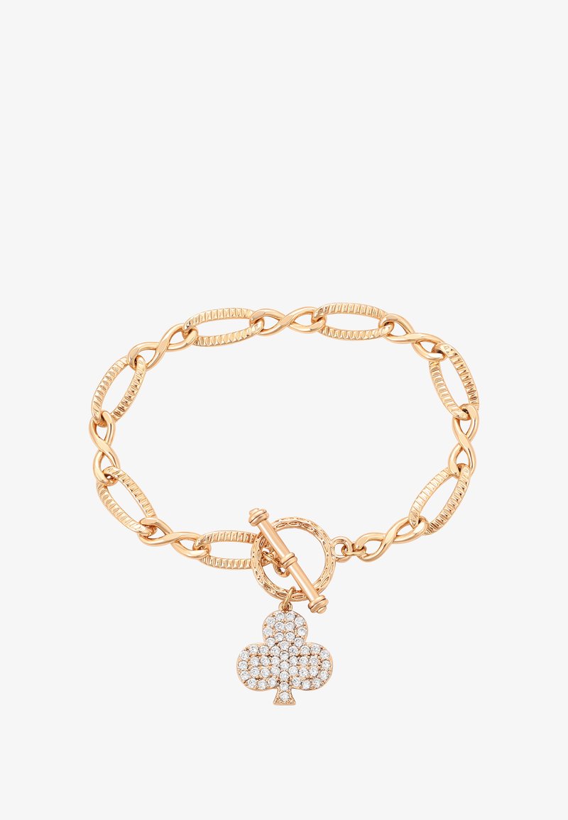 Arany színű lánc karkötő texturált gyűrűkkel és toggle záródással, négylevelű lóhere medállal, amelyet áttetsző rhinestone-ok díszítenek.