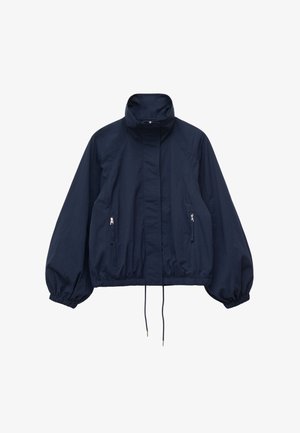 Navy blue lightweight jacket with high collar, front zipper hidden by flap, elastic cuffs, zippered side pockets, and adjustable hem drawstrings.