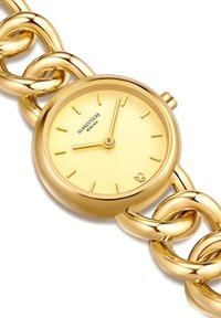 Reloj de tono dorado con esfera redonda, dial minimalista y brazalete de cadena enlazada. Superficie lisa y brillante sin patrones visibles.