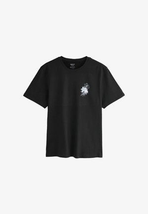 Must valdavalge lilleprindiga must puuvillane T-särk vasakul rinnal. Lühikesed varrukad ja ümmargune kaelus. Juhusliku sobivuse disain.