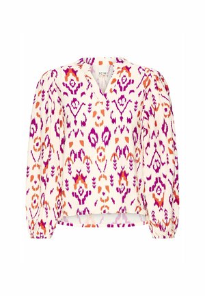 Vit blus med en livlig ikat-mönstring i rosa, lila och orange. Har en V-ringning och puffärmar med elastiska manschetter, vilket ger en lös passform.