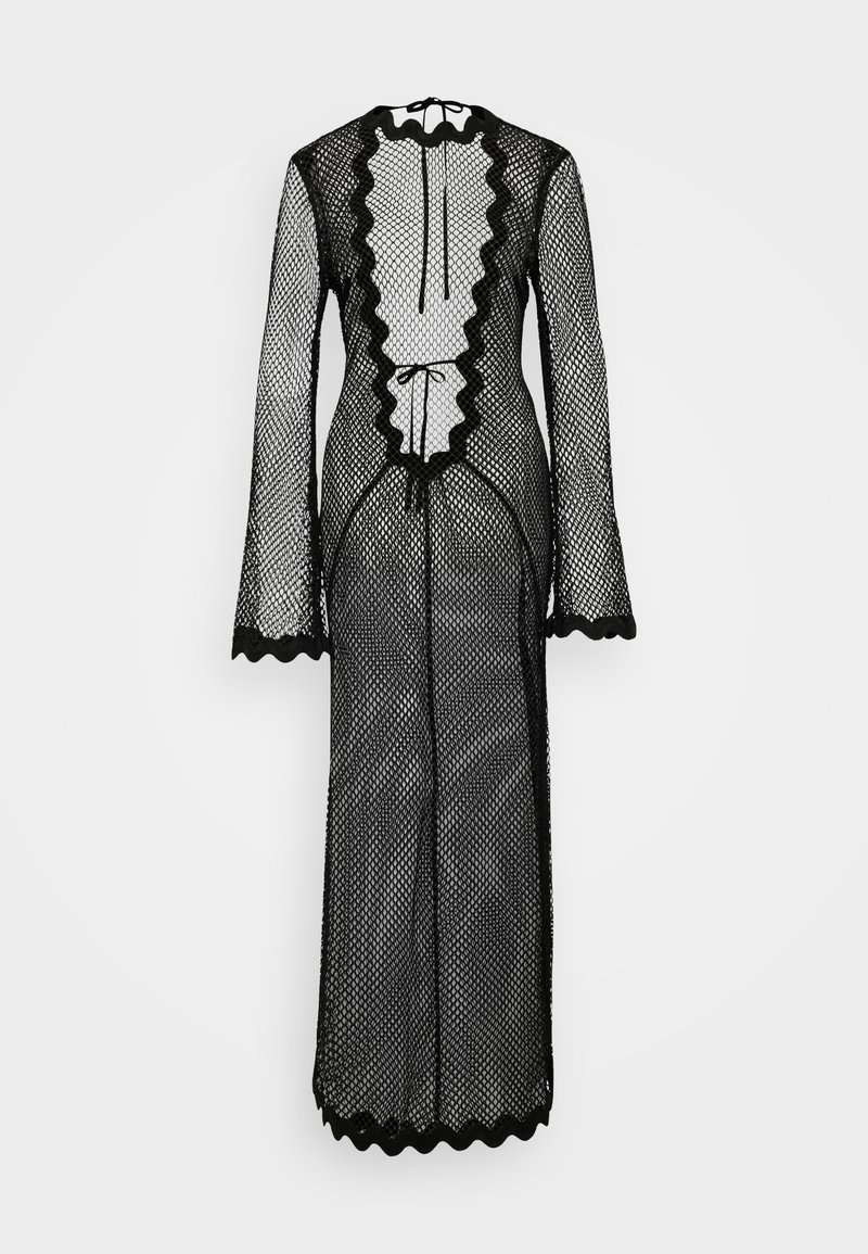 Black fishnet dress with long sleeves, scalloped edges, and a white ruffled panel down the front. Features drawstring closure at the neck.