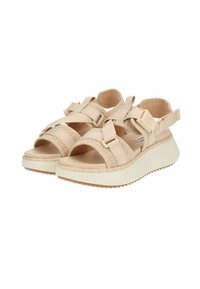 Beige Sandalen mit offenem Zeh, ausgestattet mit strukturierten Stoffriemen, verstellbaren Verschlüssen und einer dicken weißen Gummisohle mit strukturiertem Muster.