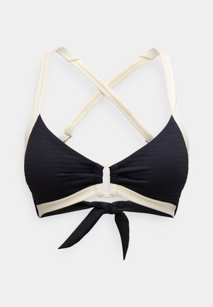 Black and cream bikini top featuring a ribbed texture, crossback straps, and a front center keyhole detail with a tie closure.