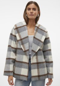 Cappotto in misto lana a quadri con ampio risvolto, in colori grigio, crema e marrone, dalla vestibilità rilassata e due tasche laterali.