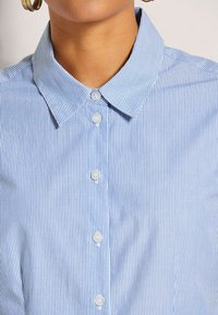 Blue and white striped shirt featuring a classic collar, button front, and smooth cotton texture with clear buttons and vertical pattern.