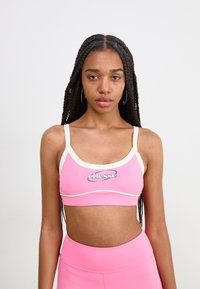 Ružový športový bralet s bielym okrajom, na prednej strane s logom "ellesse". Hladká textura, priliehavý strih a nastaviteľné ramienka.