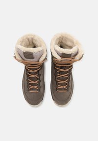 Brown suede boots with fur-lined tops, light brown laces, and a textured surface. Features a padded collar and rubber sole.