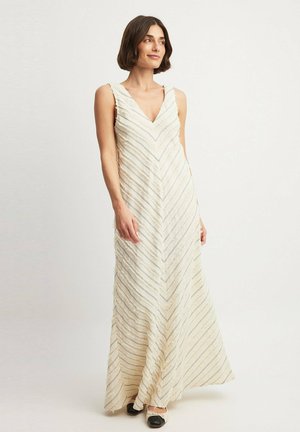 Long, cream-colored dress with V-neck, featuring zigzag patterns in silver and green. Flowing fabric with a textured finish.