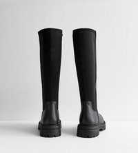 Botas negras hasta la rodilla que combinan cuero y textil, con una suela voluminoso y un acabado suave, diseñadas para un ajuste ceñido.