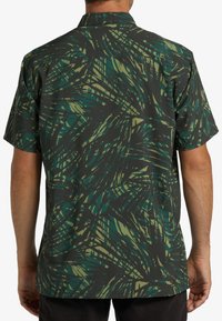 Short-sleeve shirt featuring a dark background with green and yellow leaf patterns, textured fabric, and a collar design.