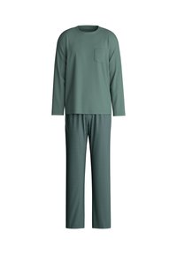 Lange mouwen groene top met een borstzak, gecombineerd met gestreepte groene broek met een geometrisch ontwerp in een contrasterende kleur.