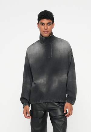 Pullover din denim negru cu guler înalt, croială lejeră și manșete elastice. Estompare graduală a culorii cu textură netedă. Asortat cu pantaloni din piele ecologică negri.