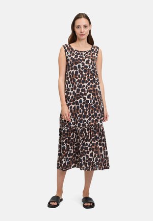 Leopard print sleeveless dress with a tiered hem, featuring brown and black spots on a light background. Worn with black slide sandals.