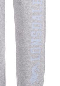 Gray sweatpants made of soft fabric feature the word "LONSDALE" printed in light blue vertically along the left leg, with a logo detail.