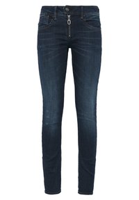 Vaqueros de denim azul oscuro con un corte slim, que cuentan con cremallera, bolsillos delanteros y un desvanecimiento sutil. Diseño clásico de cinco bolsillos.