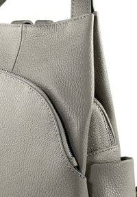 Grey leather handbag with a textured finish, featuring a zippered pocket and structured design. Smooth stitching along the edges.